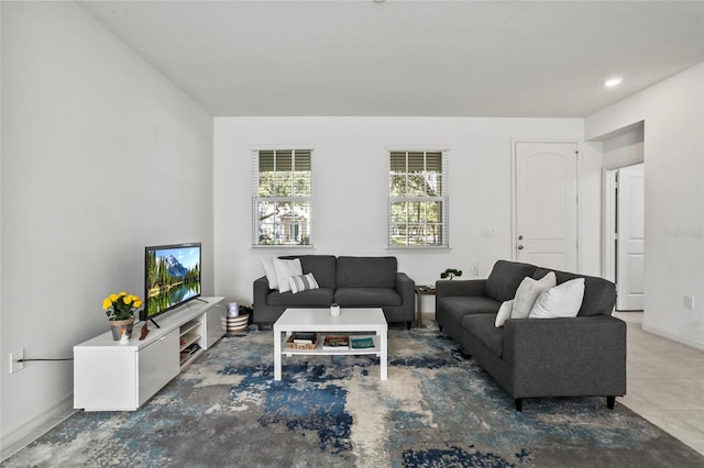 living area featuring baseboards