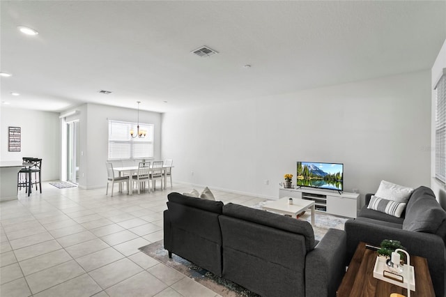 living area featuring light tile patterned floors, baseboards, visible vents, recessed lighting, and a chandelier