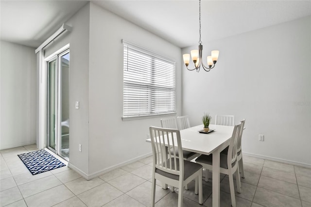 dining space with light tile patterned floors, baseboards, and an inviting chandelier