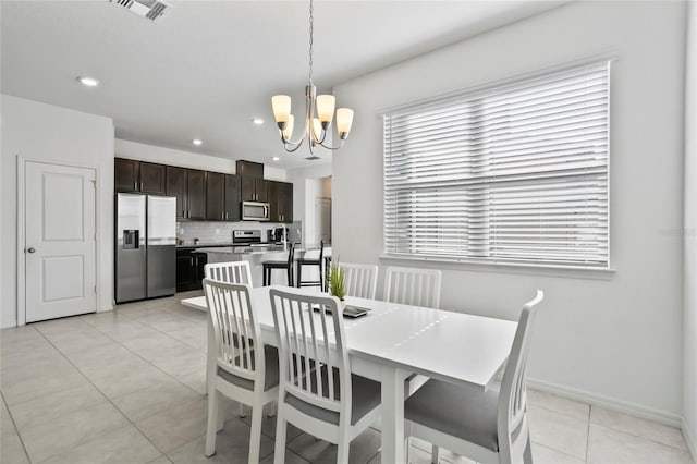 dining area with visible vents, baseboards, light tile patterned floors, recessed lighting, and an inviting chandelier