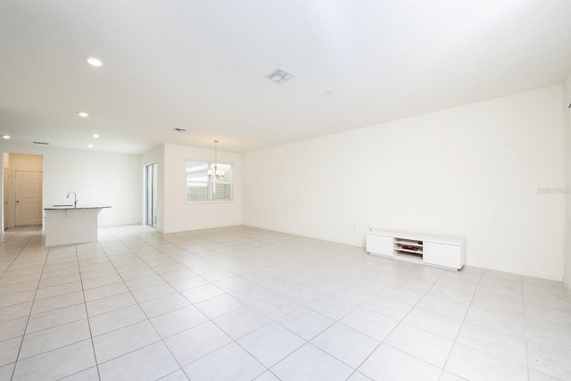 spare room with visible vents, a sink, recessed lighting, light tile patterned floors, and a chandelier