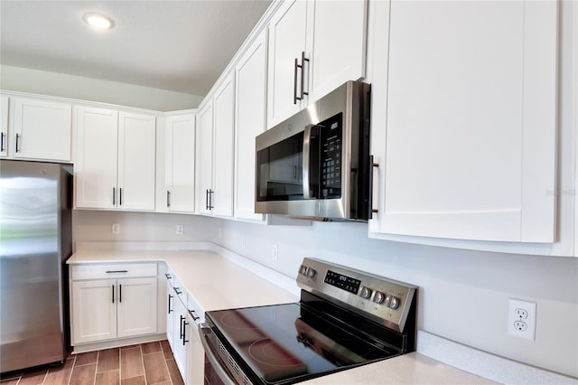 kitchen with white cabinetry and appliances with stainless steel finishes