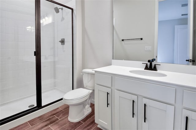 bathroom featuring vanity, toilet, and walk in shower