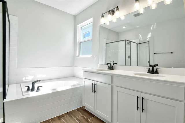 bathroom featuring vanity and separate shower and tub