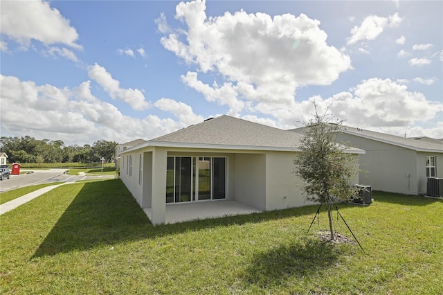 back of house with a yard, cooling unit, and a patio