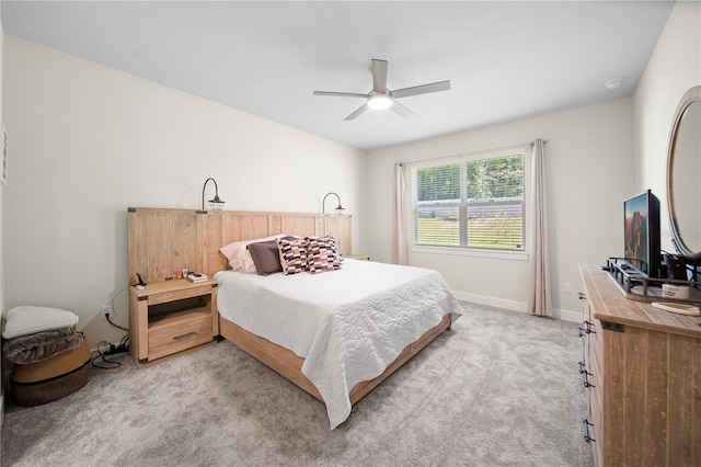 bedroom featuring light colored carpet and ceiling fan