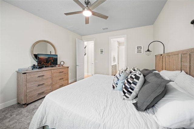 carpeted bedroom featuring ceiling fan and ensuite bathroom