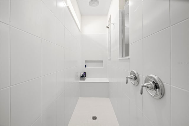 bathroom with a tile shower