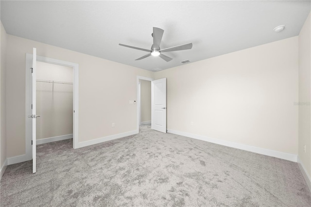 unfurnished bedroom featuring carpet, ceiling fan, and a closet