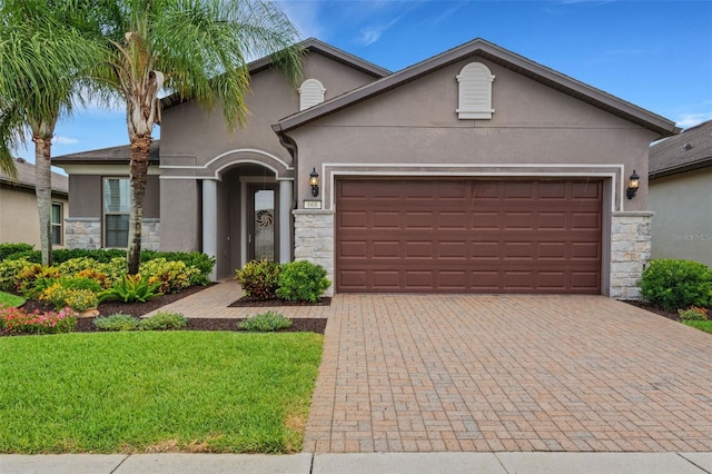 view of front of property with a front yard and a garage