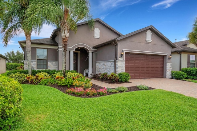 view of front of property featuring a garage and a front lawn