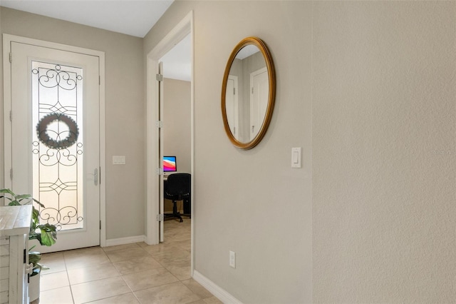 foyer entrance with light tile patterned flooring