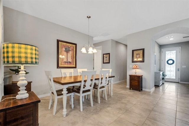 tiled dining space featuring a chandelier