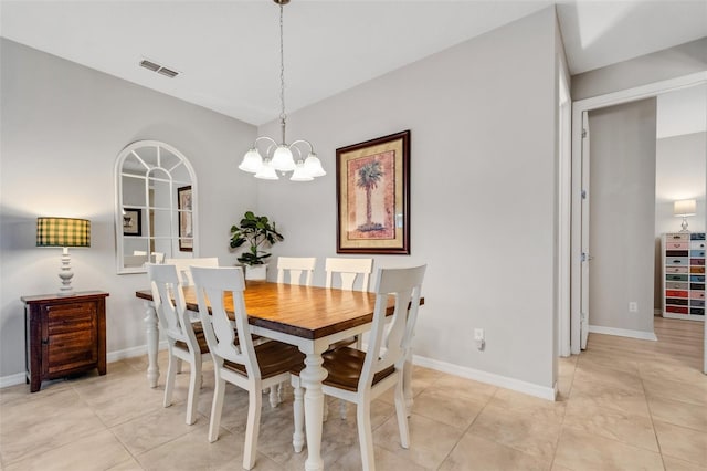 dining space with light tile patterned floors and a chandelier