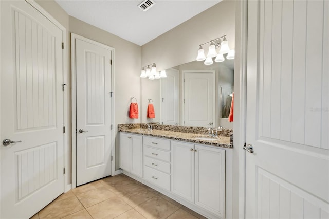 bathroom with tile patterned floors and vanity