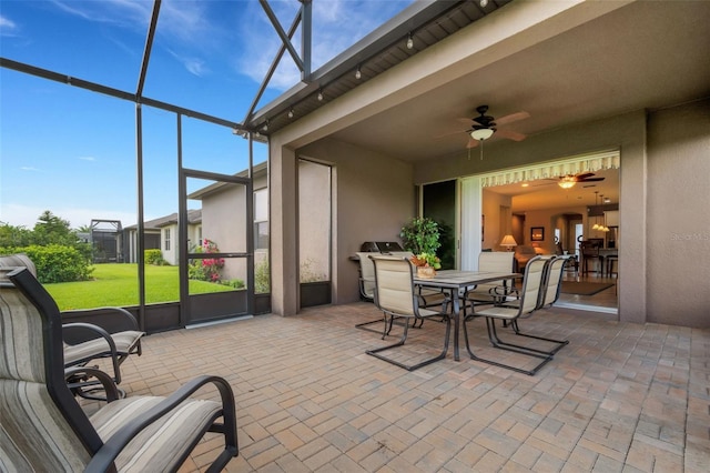 sunroom featuring ceiling fan