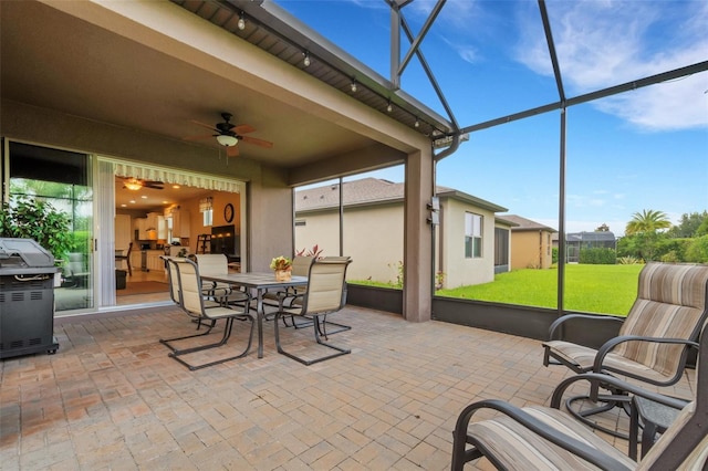 sunroom featuring ceiling fan