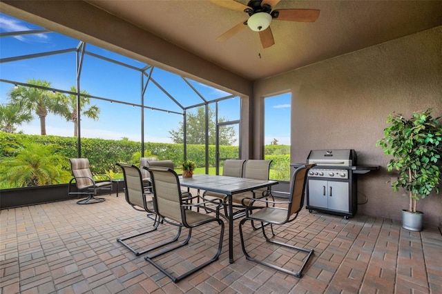 view of patio / terrace featuring a grill, ceiling fan, and glass enclosure