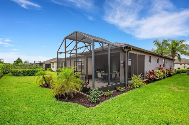 back of property featuring a yard, a patio, and a lanai