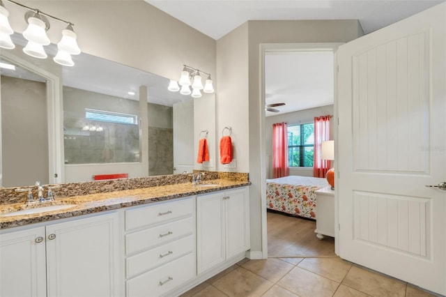 bathroom featuring tile patterned floors, vanity, ceiling fan, and a shower