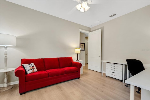 living room with ceiling fan and light wood-type flooring