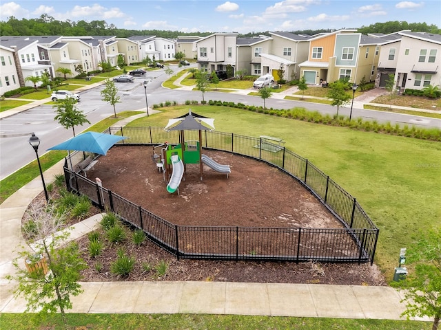 view of home's community featuring a lawn and a playground