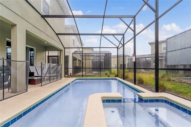 view of swimming pool featuring a lanai, an in ground hot tub, and a patio