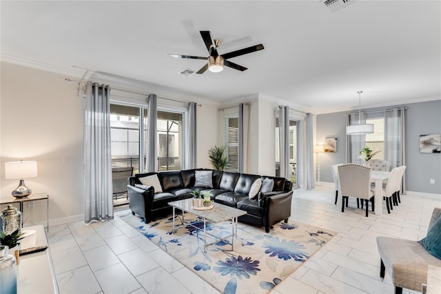 living room with ceiling fan, a healthy amount of sunlight, and crown molding