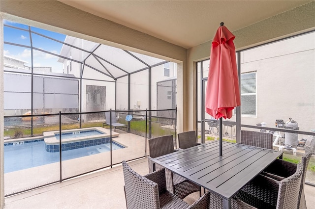 view of swimming pool featuring glass enclosure, an in ground hot tub, and a patio