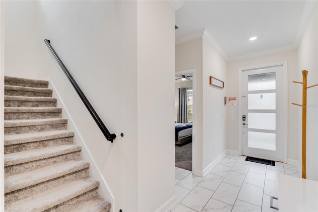 foyer with crown molding and ceiling fan