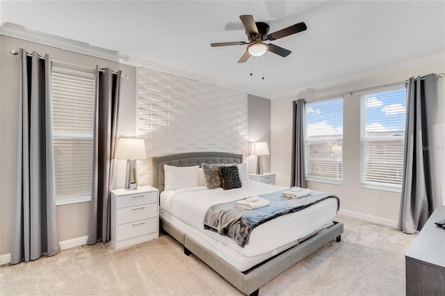 carpeted bedroom with crown molding and ceiling fan