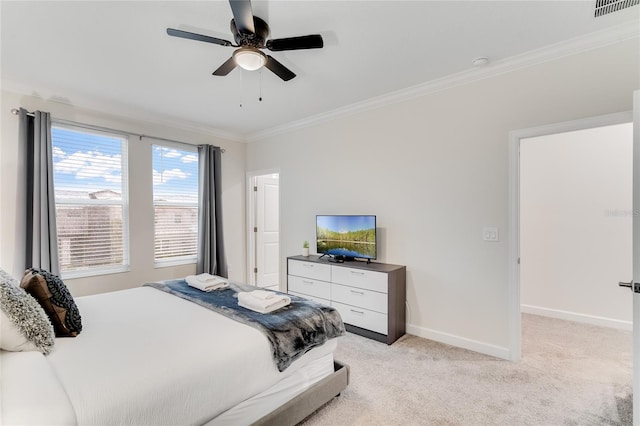 carpeted bedroom with ceiling fan and ornamental molding