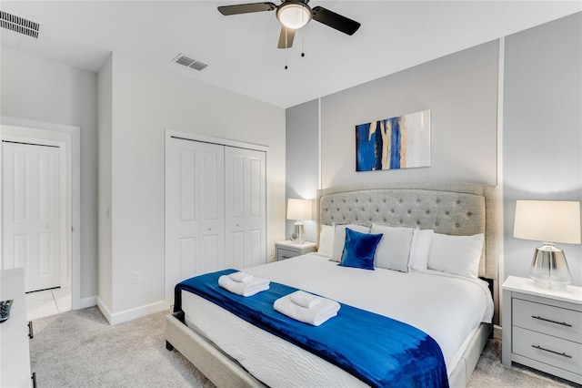 carpeted bedroom featuring ceiling fan and a closet