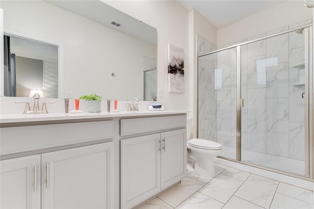 bathroom with a shower with door, vanity, and toilet