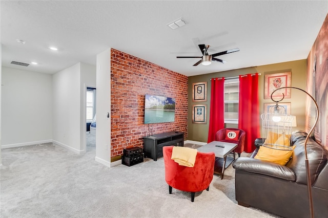 living room with a textured ceiling, light colored carpet, and ceiling fan