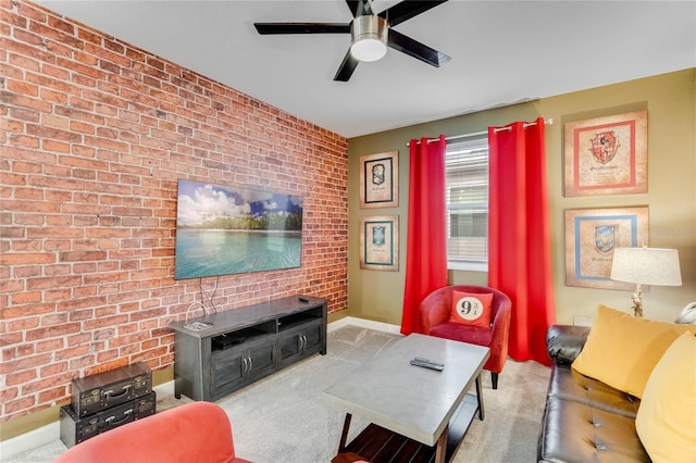 living room with light colored carpet, ceiling fan, and brick wall