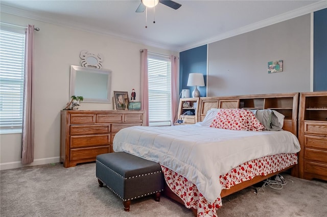 carpeted bedroom with crown molding and ceiling fan