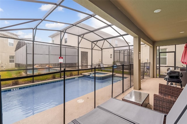 view of swimming pool with an in ground hot tub, a lanai, and a patio