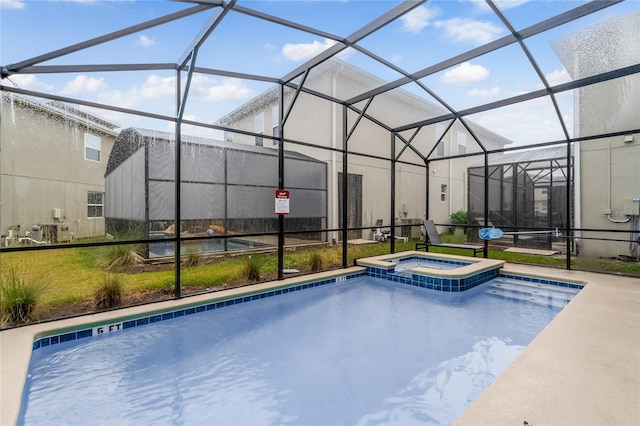 view of pool with an in ground hot tub and glass enclosure