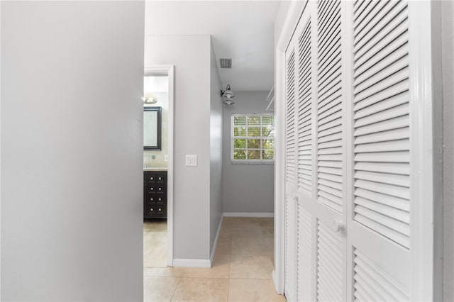 corridor with light tile patterned floors