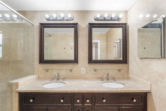 bathroom featuring tile walls, vanity, decorative backsplash, and a shower with door