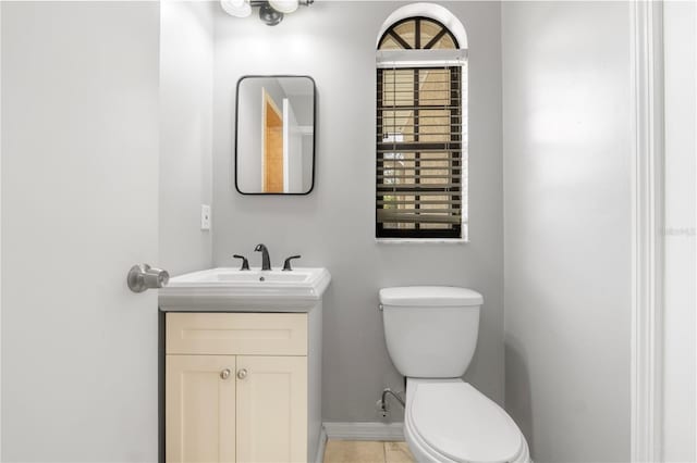 bathroom featuring vanity, toilet, and tile patterned flooring