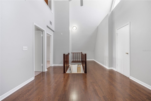 interior space with dark wood-type flooring and high vaulted ceiling