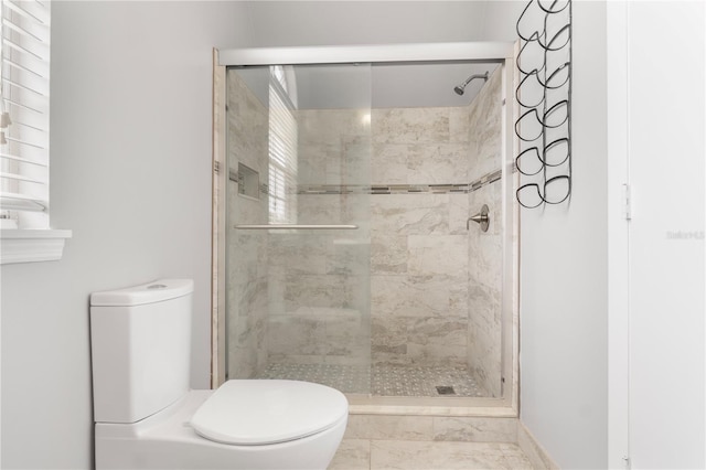 bathroom featuring an enclosed shower and toilet