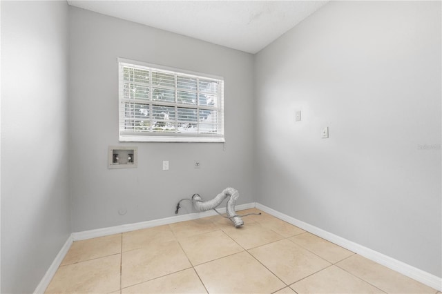 clothes washing area featuring gas dryer hookup, hookup for a washing machine, and light tile patterned floors