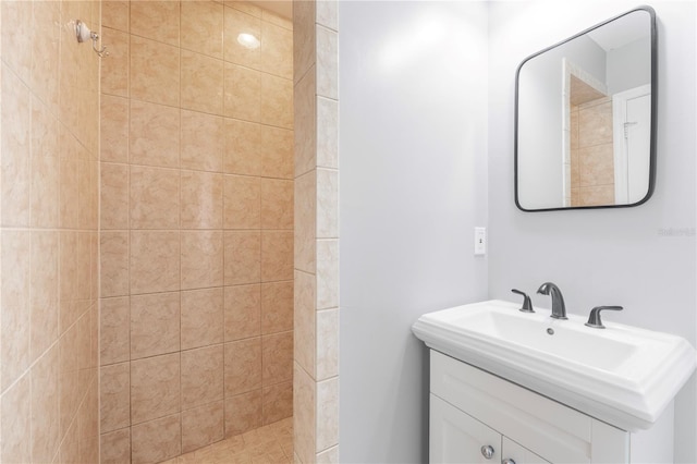 bathroom with sink and a tile shower