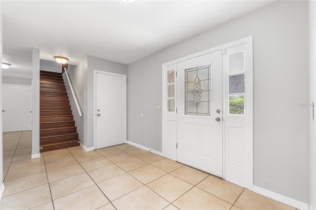 entryway with light tile patterned flooring