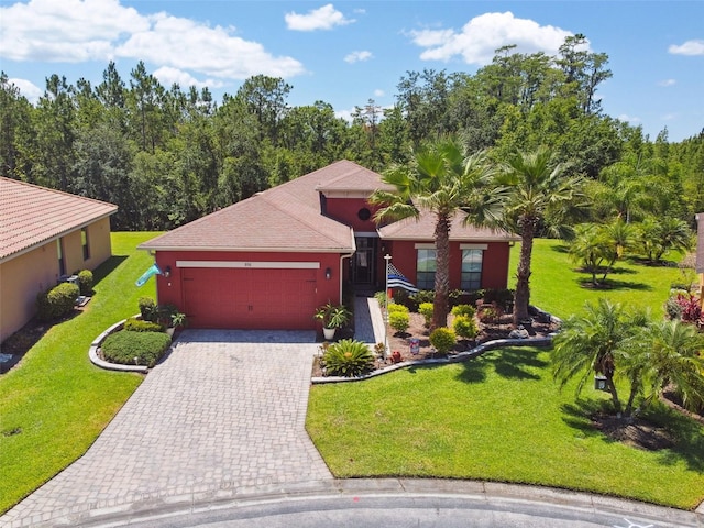 view of front of house featuring a garage and a front lawn