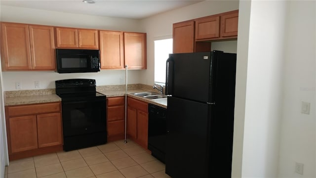 kitchen featuring sink, black appliances, and light tile floors