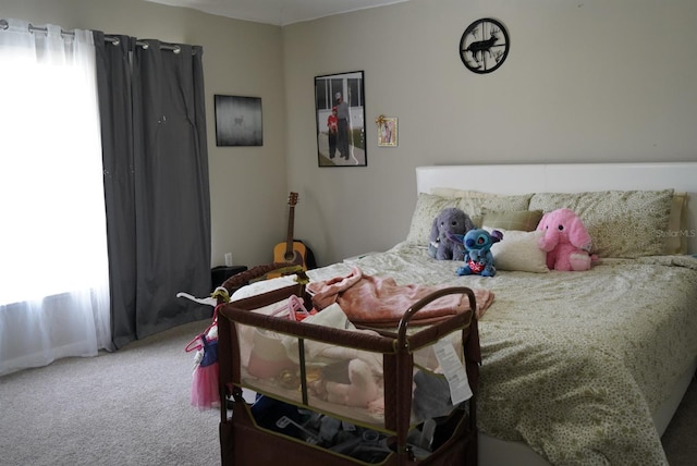 bedroom featuring multiple windows and carpet floors